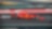 Voiture Ferrari F1 numéro 16 en action sur un circuit de course avec bordures rouge et vert