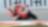 Moto Ducati rouge numéro 7 penchée dans un virage sur circuit, avec pilote portant un casque coloré