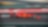 Voiture Ferrari F1 numéro 16 en action sur un circuit de course avec bordures rouge et vert